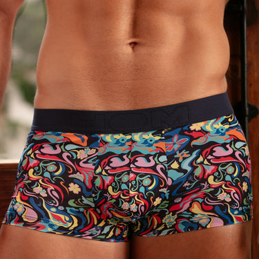 Colorful patterned underwear worn by a person with a blurred background